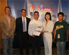 Mr. Tom Chan (third from left) receives the prize from Ms Doris Cheung, Director of the Hong Kong Economic and Trade Office in San Francisco.  Also pictured here are representatives from KRON 4, Bay Area News Station and Ming Pao Daily.